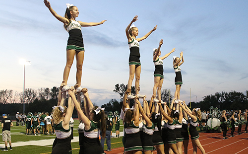 DHS cheerleaders fly high at home Football game.