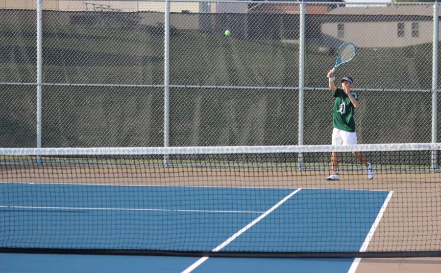 Senior Tait Theel returns a shot in a doubles match against opponents from Spring Hill on April 5.