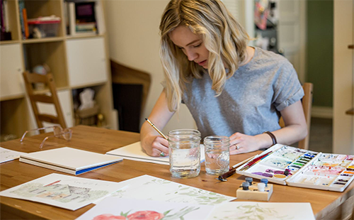 Shaw works on her artwork in her home studio. 