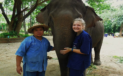 Grieshaber poses with an elephant and a local