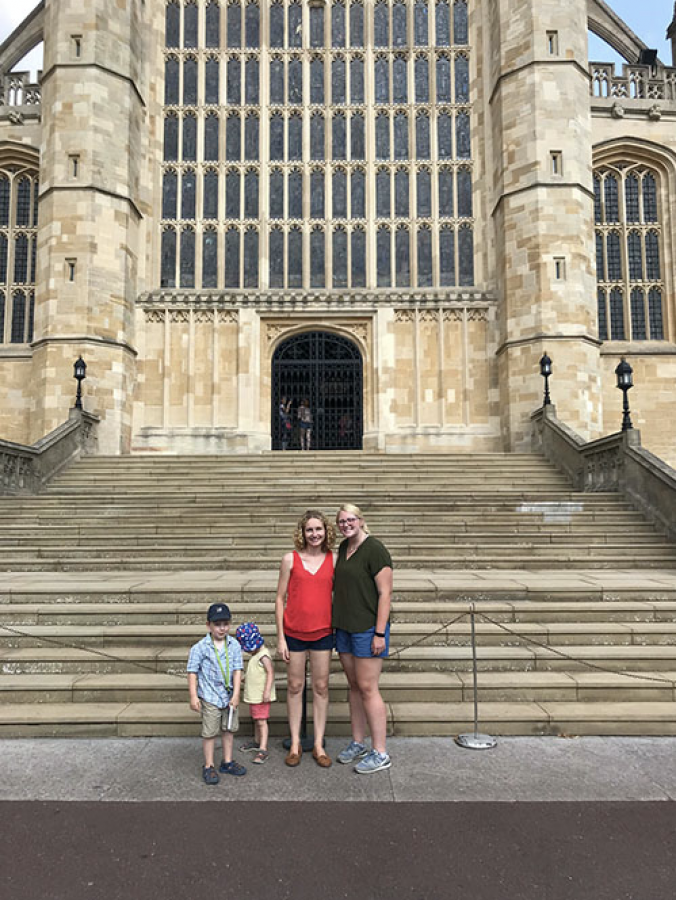 Senior Kasey Seaba standing in front of the Windsor Castle Cathedral in Berkshire, England, with the family she stayed with over the summer in Andover, England.
