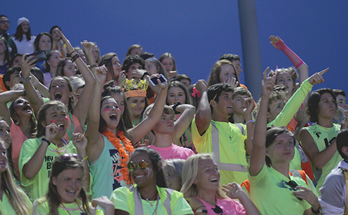 Students decked out in neon apparel celebrate during a football game in the 2017 season. Pep Club will be supporting similar school events in the 2018-19 school year.