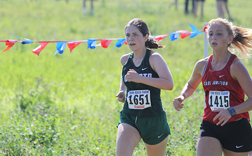 Senior Alyssa Perry pushes through the five kilometer girls’ cross country race at Rim Rock Farm on Sept. 23, 2017.