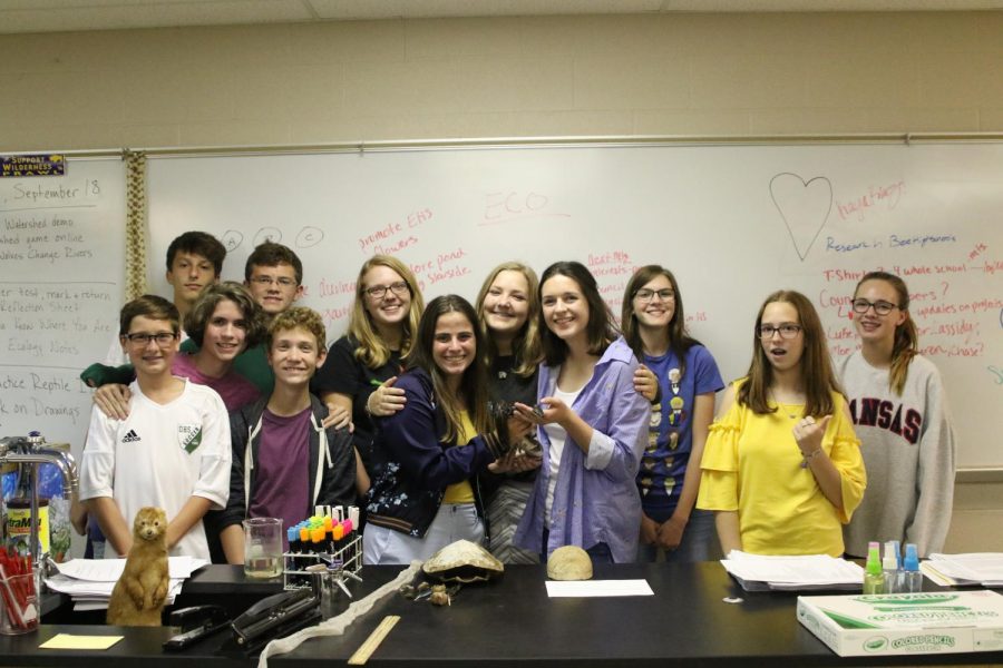 Luke LeBar, Caleb Kmiecik, Connor McCall, Kendan Powers, Andrew Poulain, Lauren Mallicoat, Morgan Laney, Aspen Grieshaber, Lauren Stanton, Cassidy Harris, Emily Kresin and Alli Rozelle stand around  Negini, a ball python, after discussing the expectations and events of Environmental Club.