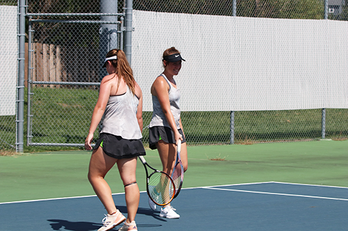 Sophomores Jenna Doran and Hallie Scott encourage each other in between serves on Sept. 15.