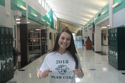 Sophomore transfer student Ella Boxx shows off her new DHS shirt in the main hallway on September 25. 