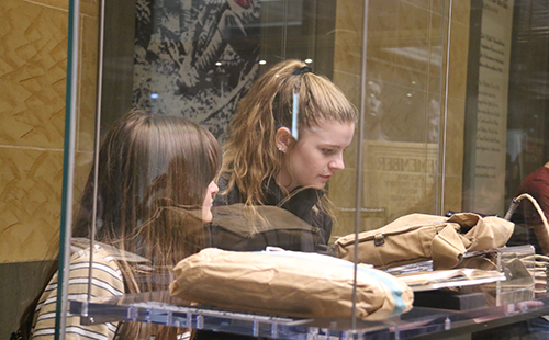 Juniors Camryn Robbinson and Hayley Moss carefully view different artifacts at the National World War I Museum on Oct. 3. 