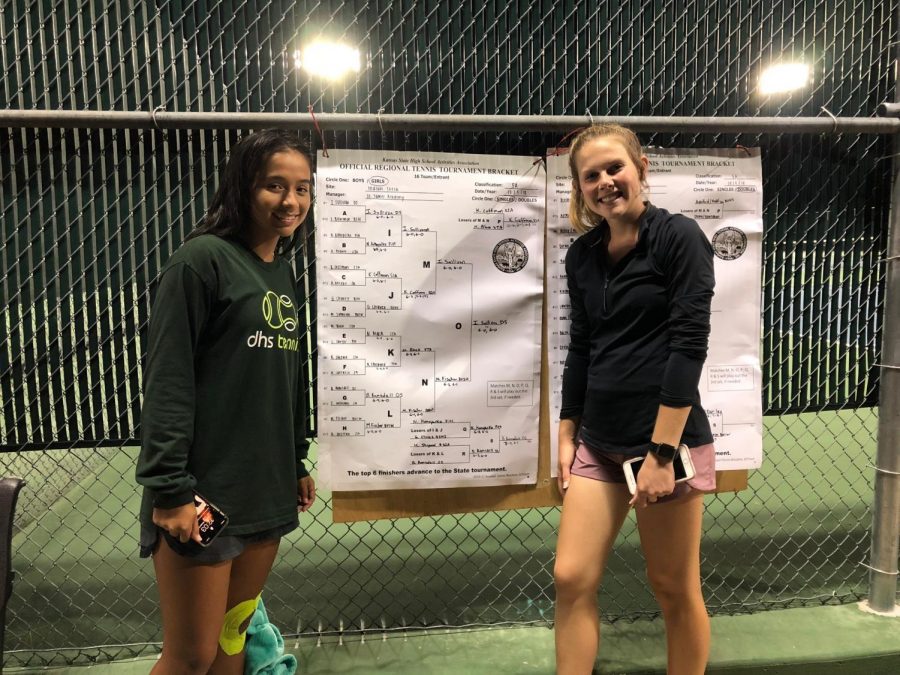 Junior Issa Sullivan and senior Bailey Ramsdell pose in front of the Regional bracket after the two finished play close to midnight on Oct. 5. Both players qualified for the 5A State tournament which will be held at Emporia High School Oct. 12-13. 