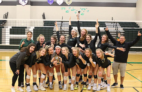 The De Soto High School varsity volleyball team celebrates after defeating Lansing to win the championship game at Spikefest on Oct. 5.