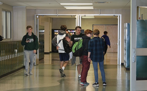 Sophomore students socialize in the hallway before leaving for grade check early release. 