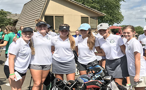 The girls’ varsity golf team poses for a photo at the Overland Park Golf Course on Sept. 9.  
