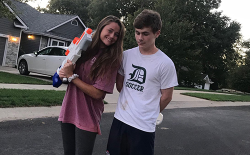 Seniors Loren Hinkle and Daniel Apple pose for a picture after Hinkle 'assassinated' Apple with a water gun on Sept. 26. 