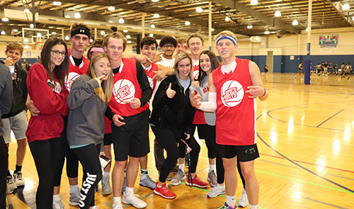 A group of junior supporters pose with the team for a picture after the Spice Boys game on Nov. 13 at Okun Fieldhouse. 