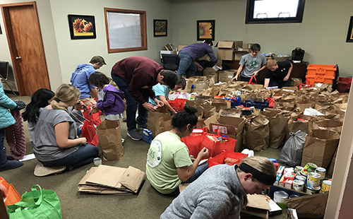 National Honors Society students help package food for families in need at the De Soto Food Pantry on Nov. 16 and 17. 