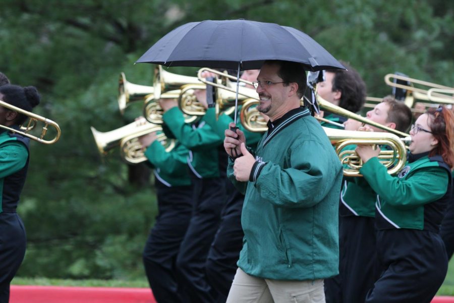 De Soto band director Matt Bradford walks alongside the DHS Marching Wildcats on Sept 7, 2018.