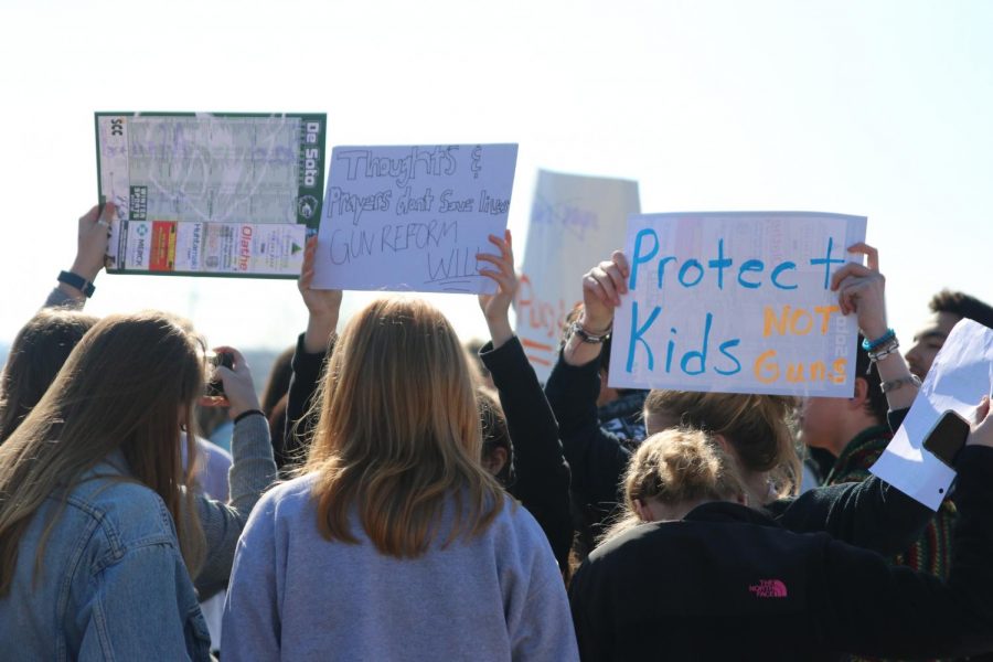 De Soto High School students protest gun control laws after the Parkland school shooting during a school walkout on March 8, 2018. 