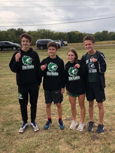 Freshman Katelyn Gress shows off her cross country medal along with her teammates at the Topeka-Seaman meet on Sept. 29, 2018.       
