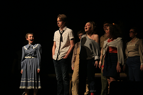 On Feb. 24, the cast gathers around senior Trace Harre during a scene where Ren learns the constraints the town has on teenagers.