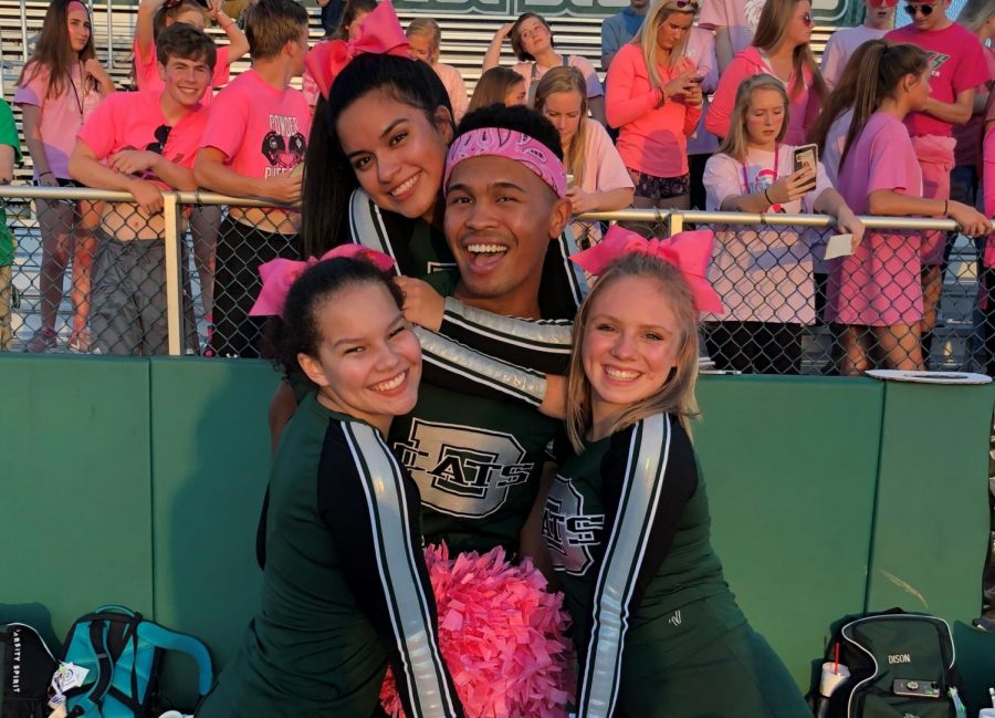 Senior captains Lexi Marshall, Aylin Rocha, Zekkiah Hird and Ellie Fowks pose for a photo prior to cheering at a home football game against Basehor-Linwood on Oct. 5.