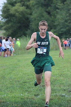 Freshman Clayton Tilley crosses the finish line during the first home cross country meet at Lexington Lake on Sept. 6, 2018. 