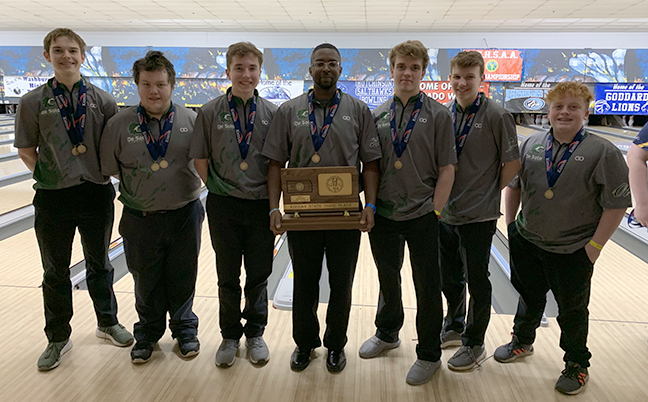 Boys' bowling team stands proudly holding their third place trophy at the state tournament. on Feb. 28.