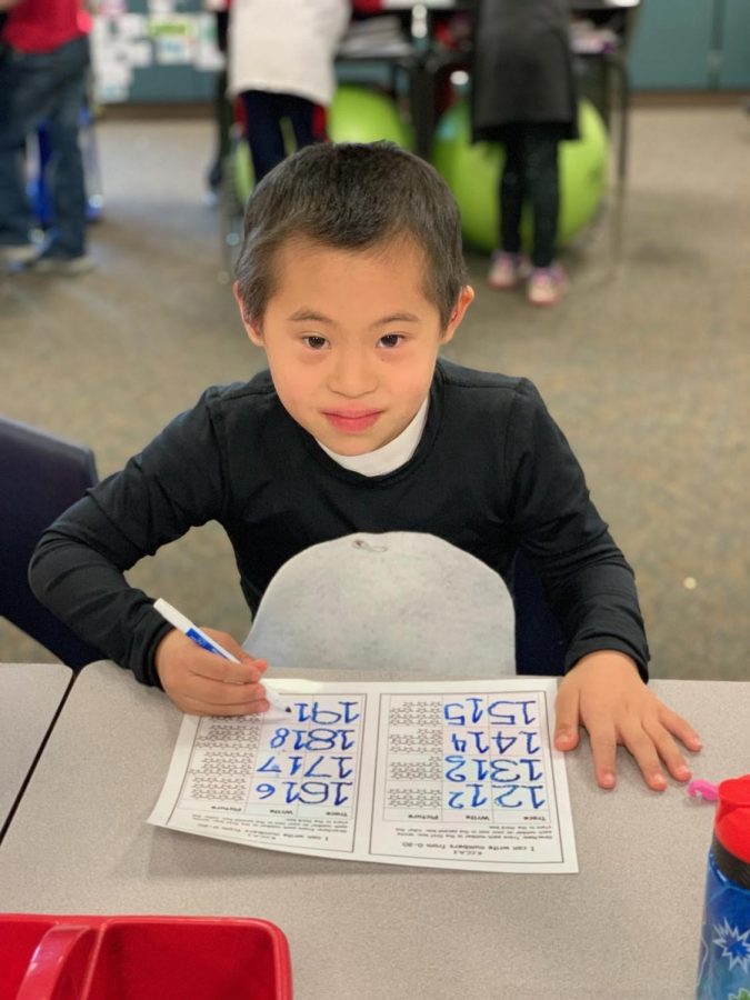 Mize Elementary second grader Ben Meehan, who has Down Syndrome,  works on writing his numbers in his classroom. 