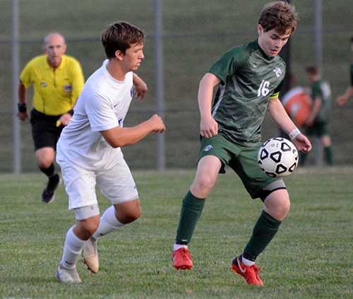 Senior Daniel Apple prepares to battle for the ball during his 2018 season. Despite difficult injuries that kept him from soccer for a year, Apple signed to play at Baker University in the fall.