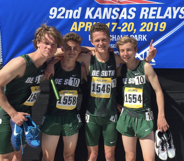 Junior Samuel Hashagen, sophomore Carson Sturdy, junior Chase Culver and freshmen Brady Huggins pose after running their distance medley relay on April 20 at the Rock Chalk Park in Lawrence.