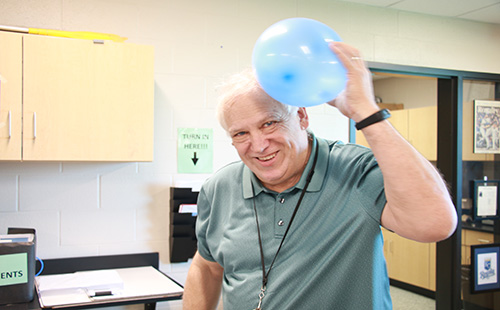 DHS long-term physics sub Ron Lewis demonstrates the physics of rubbing a balloon on one’s head. 