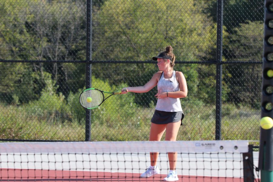 Junior Hallie Scott makes contact with the ball on her forehand at Lansing Quad on Sept. 26.