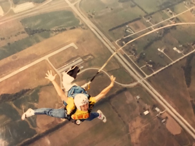 Elizabeth Crainshaw prepares for her parachute to open after letting go of the wing of a plane. 
