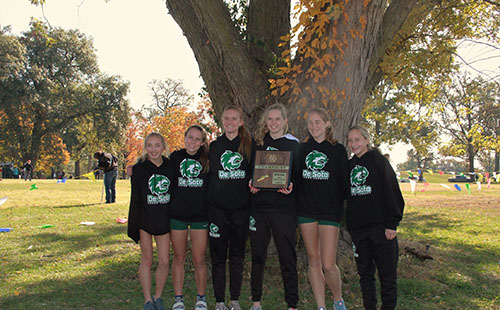 The De Soto High School girls cross country team poses with their regional championship trophy at the Regional cross country meet on Oct 26. 
