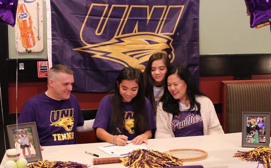 Senior Issa Sullivan signs her national letter of intent to play college tennis at the University of Northern Iowa at a ceremony with family and friends on Dec. 6, 2019. 