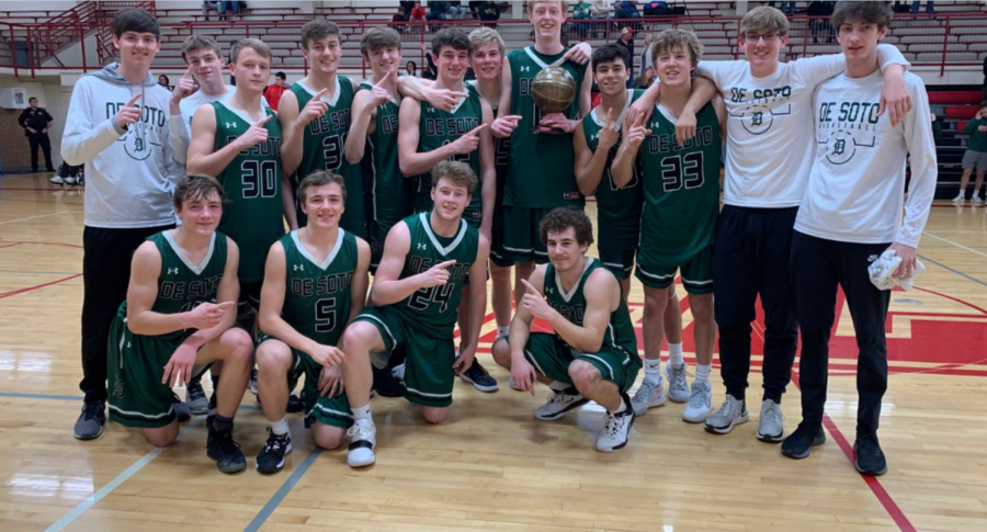 The De Soto high school boys' basketball teams celebrates its championship after winning the Tonganoxie Invitational on Jan. 25.