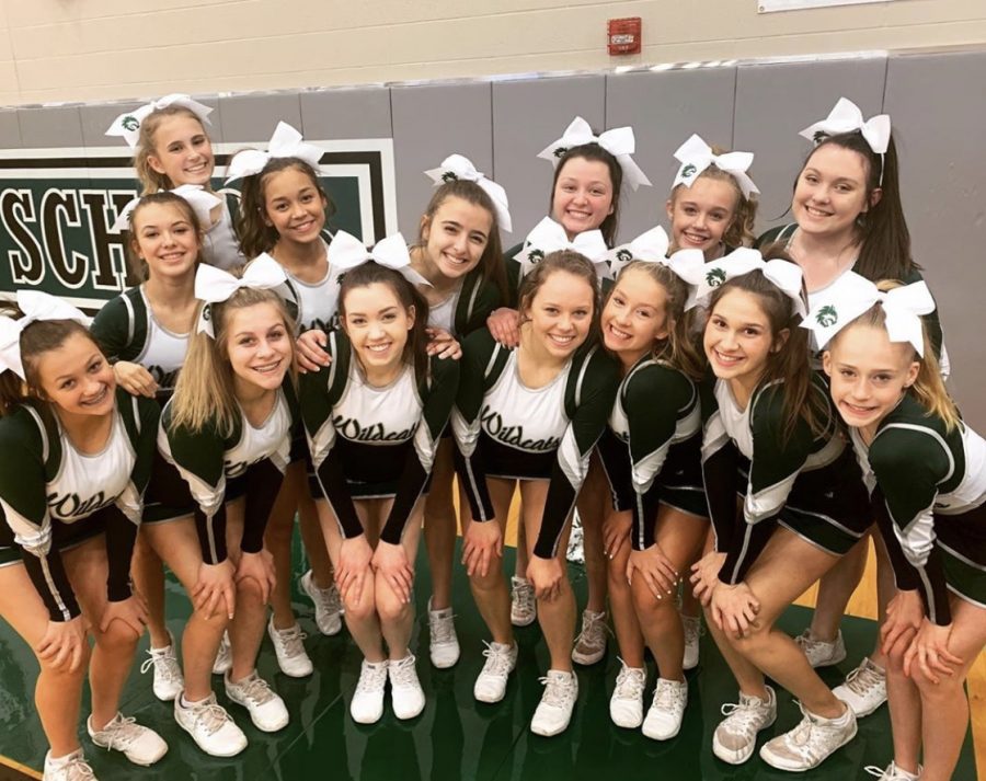 De Soto Cheer team poses for a group photo during one of their regular season basketball games. 