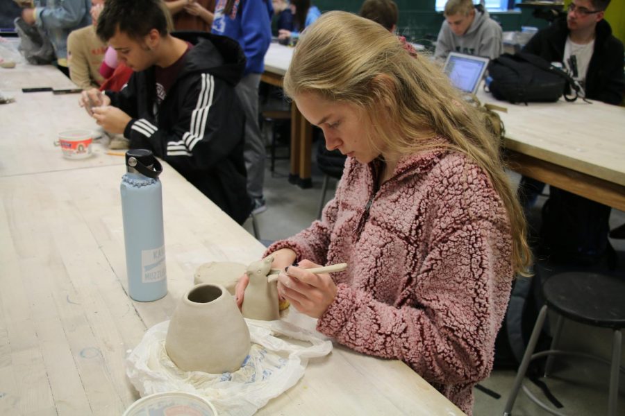 Senior Justine Wheeler works on project for sculpture class.