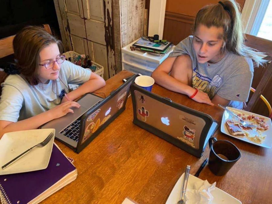 Senior Kyra Halvorsen spends time with her younger sister on April 1 completing online coursework throughout the COVID-19 quarantine.