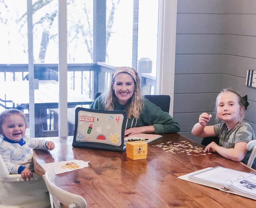 Caroline Friday and her children, Harper and Hudson Friday, work on virtual school at home on April 17.