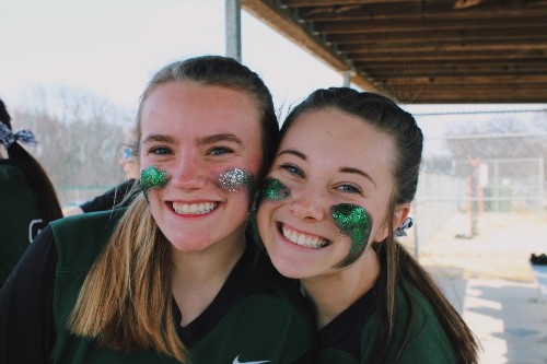 Senior Delaney Lecluyse and junior Ella Box share their team spirit during their first home game of the season against Leavenworth on March 26, 2019. The Wildcats ended up winning these games. 