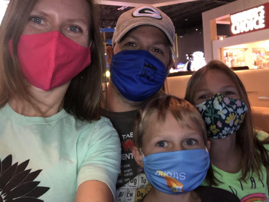 DHS social studies teacher Cathryn Monroe and her husband, daughter and son pose for a selfie while wearing their masks.