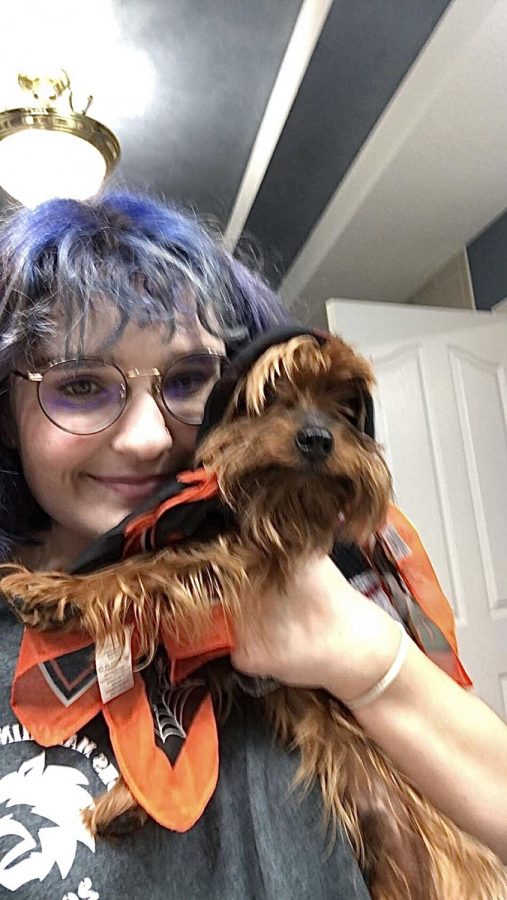 Junior Emily Bell poses with her dog TJ while taking a break from working on online homework.
