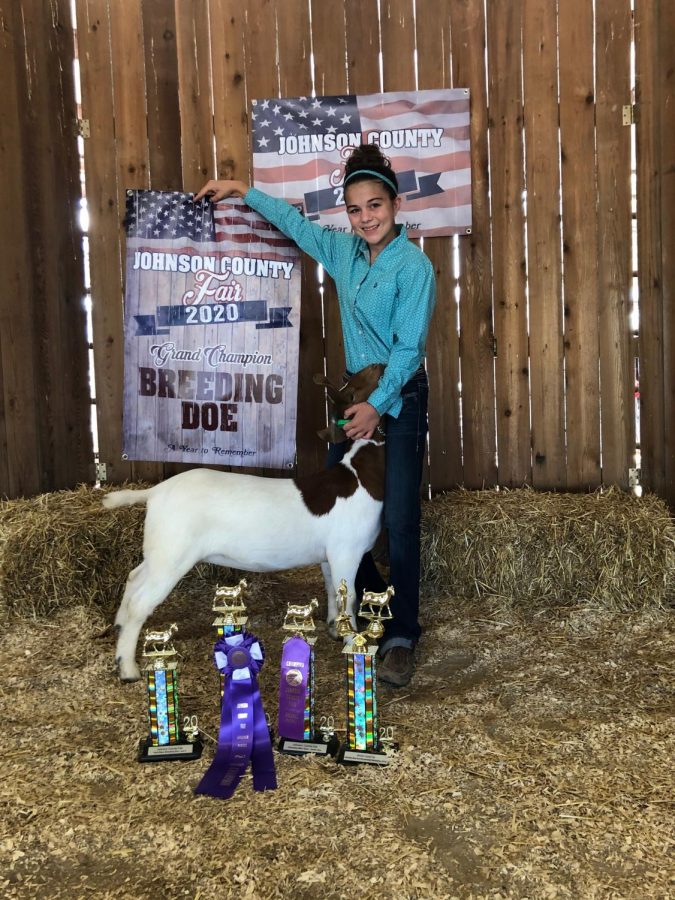 Freshman Kaylee King poses with one of her goats at the 2020 Johnson County Fair. King was the champion for the breeding doe category at the competition.