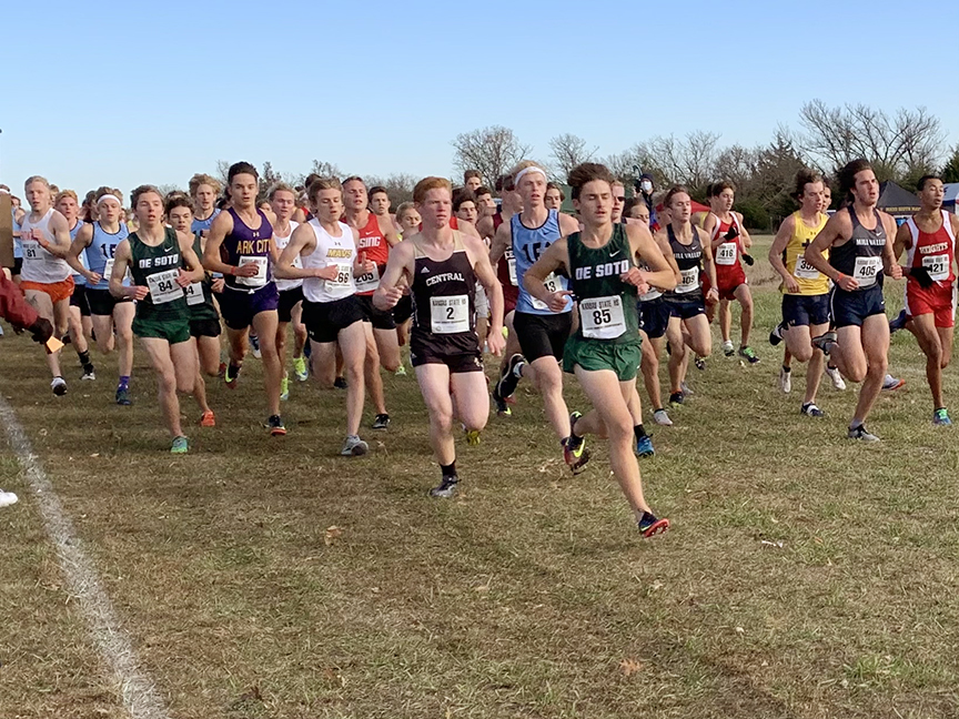 Senior Carson Sturdy and junior Brady Huggins  jump out at the start of 5A State Championship cross country race on Oct. 31.