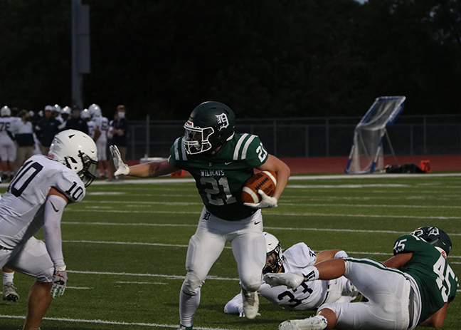 De Soto High School senior running back Tyson Priddy avoids a Mill Valley defensive player during Wildcats loss to the Jaguars on Sept. 11.