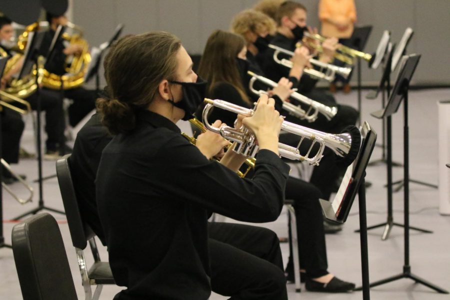 Several trumpet players from the De Soto High School band perform with their masks and bell covers to minimize the spread of germs during their concert on Dec. 14. 