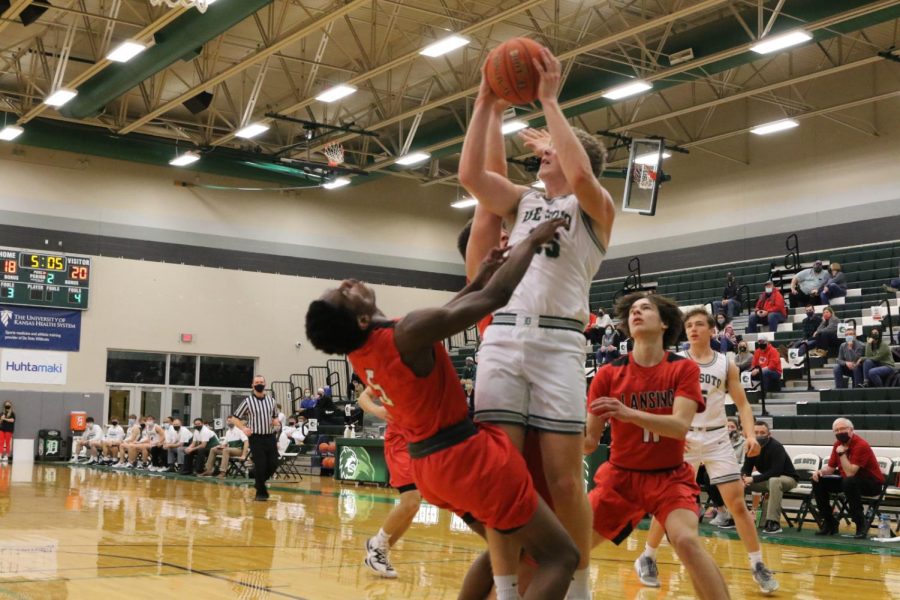   Senior Wyatt Noll attempts to score over a Lansing defender on Jan. 15. Taken By Ryan Johnson
