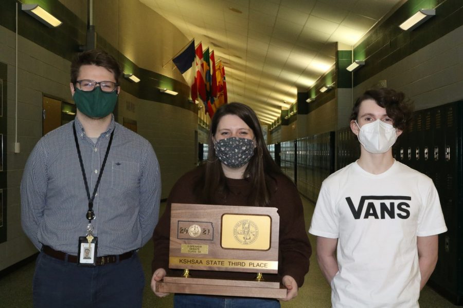 DHS Debate teacher Will Mercer, senior Hunter Finerty and junior and Ryan Handley pose with their third-place trophy from the 05A Two-Speaker State Debate Tournament.