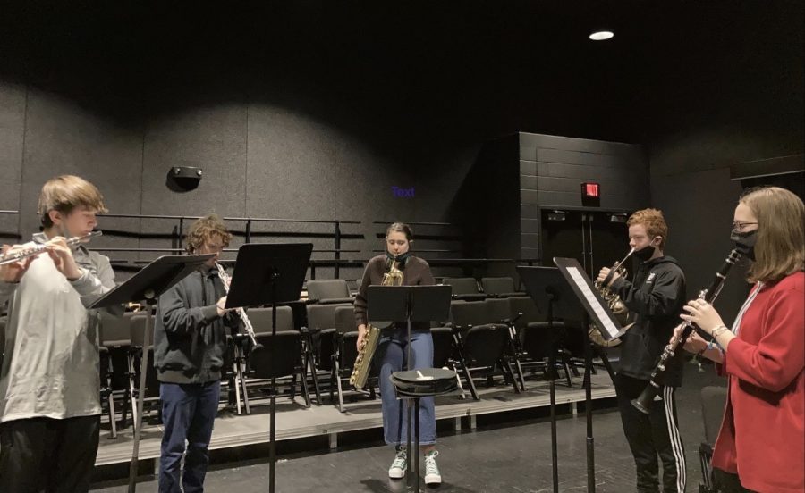 Sophomore Trever Tilton, juniors Casey O'Donnell and Ollie Kellogg, sophomore Ryan Lange and senior Emily Kresin rehearse their piece in the Black Box Theatre on March 1 for their upcoming ensemble performance.