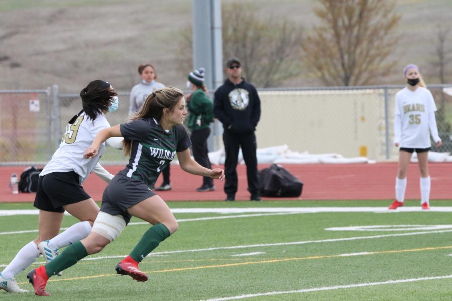 Senior Jordan Zade dashes after a ball during a game on April 22. Zade is a crucial aspect of the girls’ soccer team, and her upcoming return will undoubtedly have a positive effect on the team’s future performances.