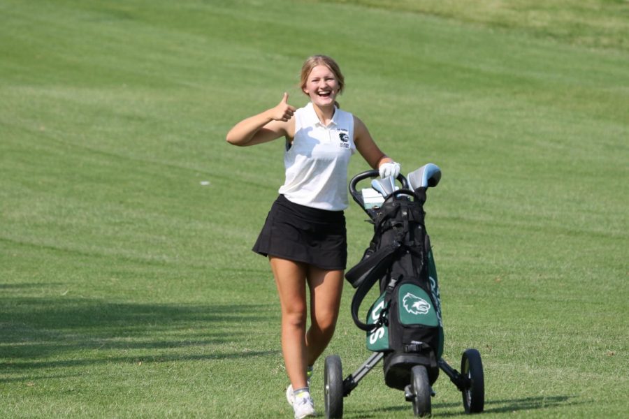 Sophomore Maggie Bichelmeyer poses for a picture during the golf tournament at Painted Hills on Sept. 9.